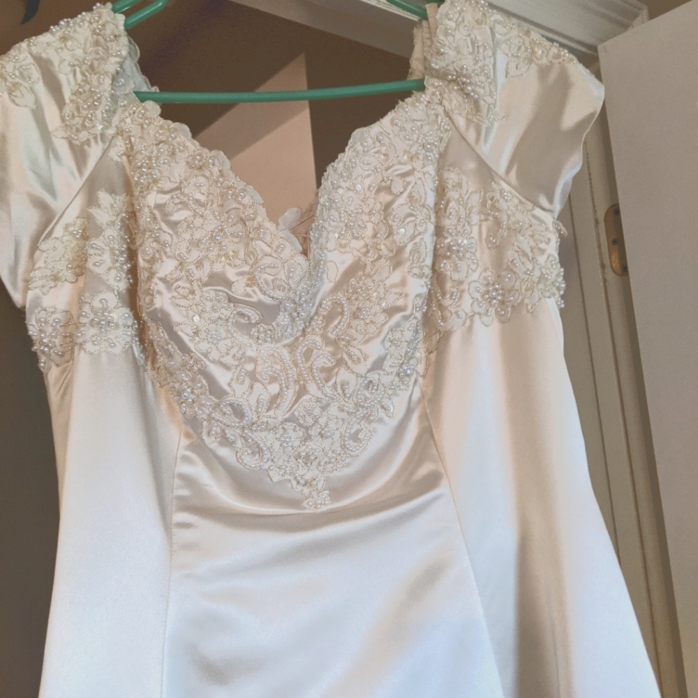 Wedding gown, designer is Sweetheart Gowns. Size 12. Candlelight color.